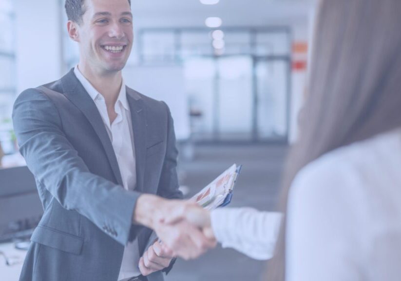 Job candidate shaking hands with an interviewer, preparing for a successful job interview at ResponsAble Staffing.