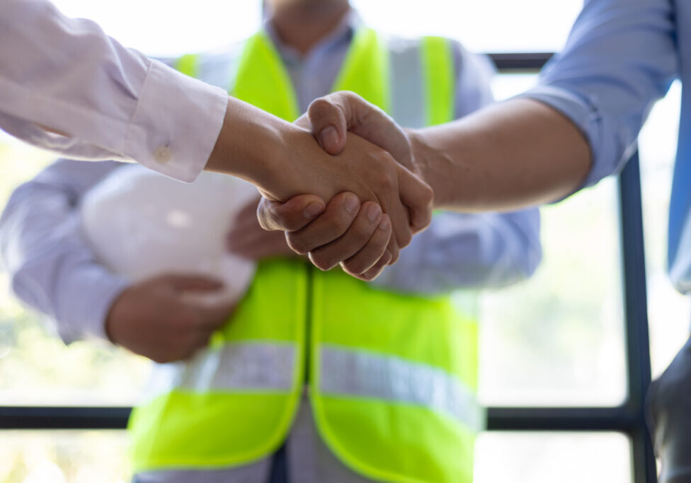 Safety manager hired through direct hire EHS staffing reviews site plans with foreman at construction project